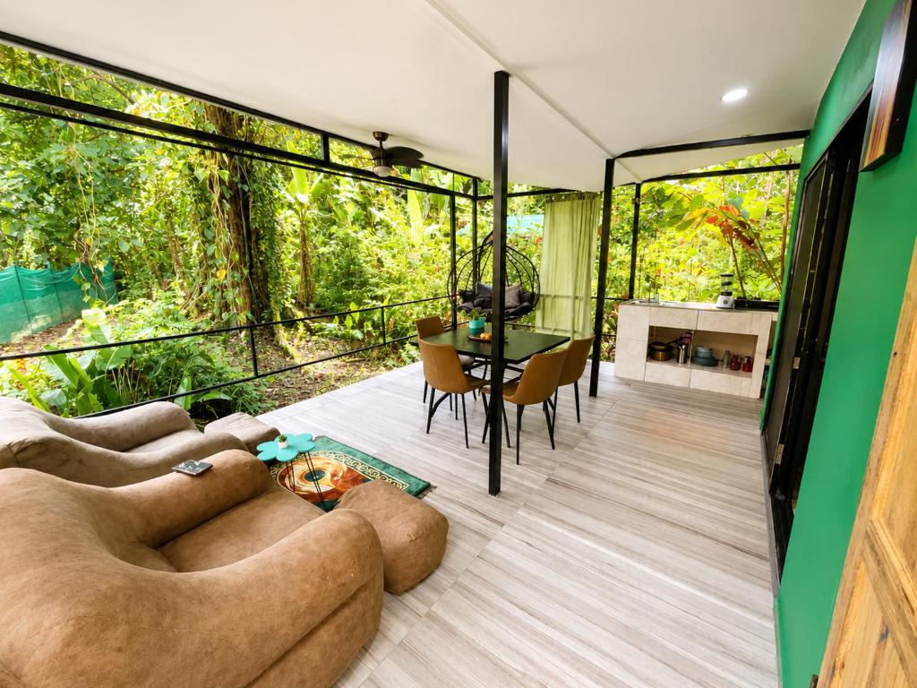 a living room with a couch and a table at Jungle Serenity Haven in Cocles