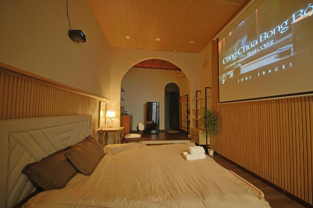 a bedroom with a bed with a sign on the wall at Àla Homestay Cần Thơ in Can Tho