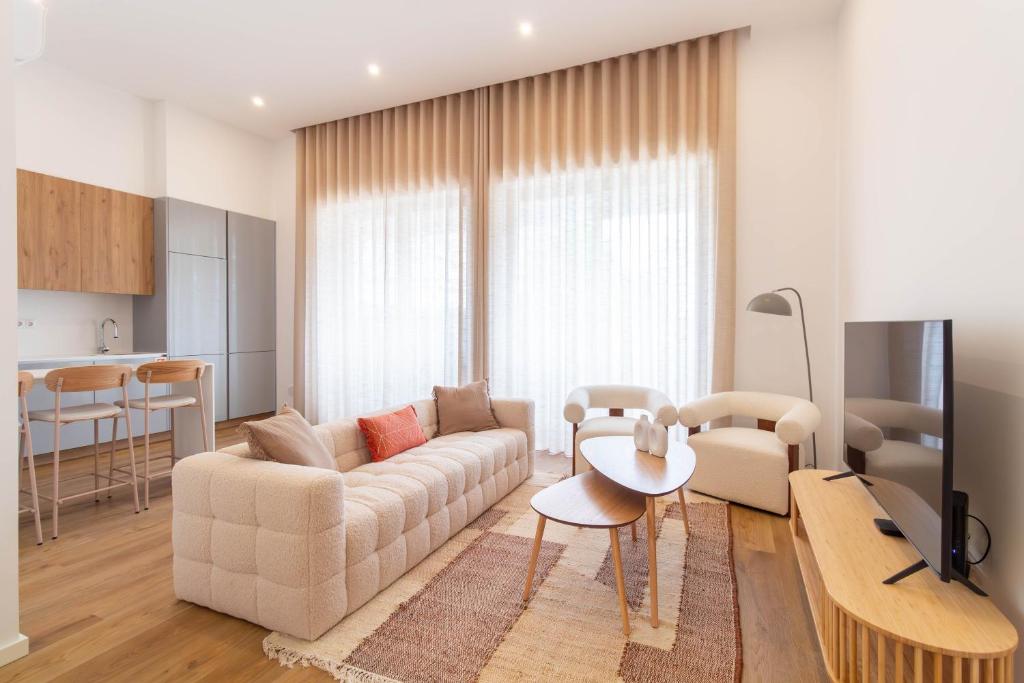 a living room with a couch and a table at ASTRO Emanuelle E by LovelyStay in Leça da Palmeira