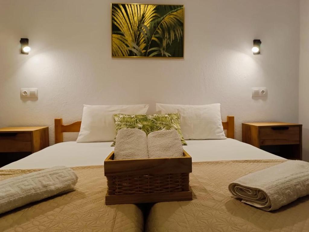 a bedroom with a bed with two towels on it at Elena Apartments in Keramoti