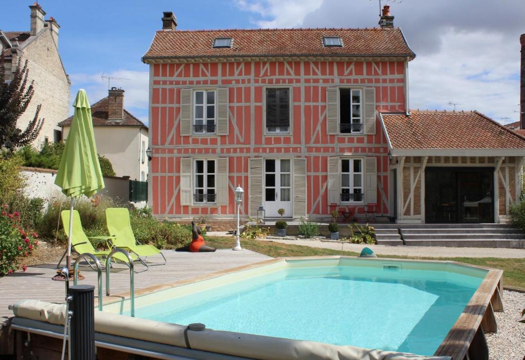 a house with a swimming pool in front of a house at La chabrouchine in Sainte-Savine