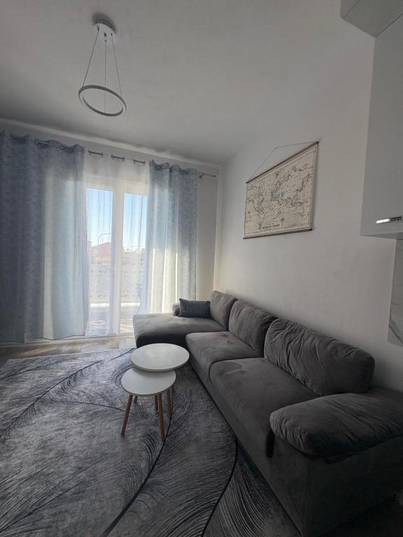 a living room with a couch and a table at ARMAS Stay in Kamëz