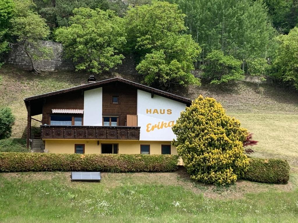 a house with a sign on the side of it at Ferienhaus Erika in Telfs