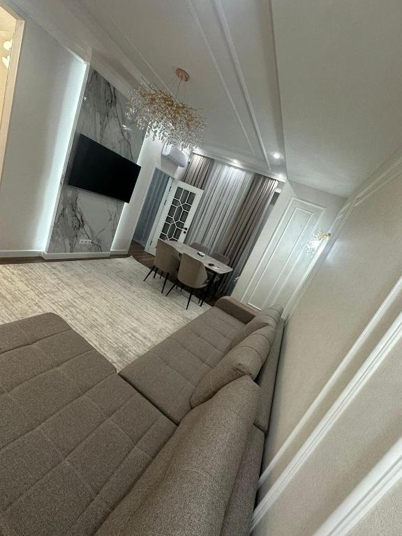 a living room with a couch and a table at Бахт in Bishkek