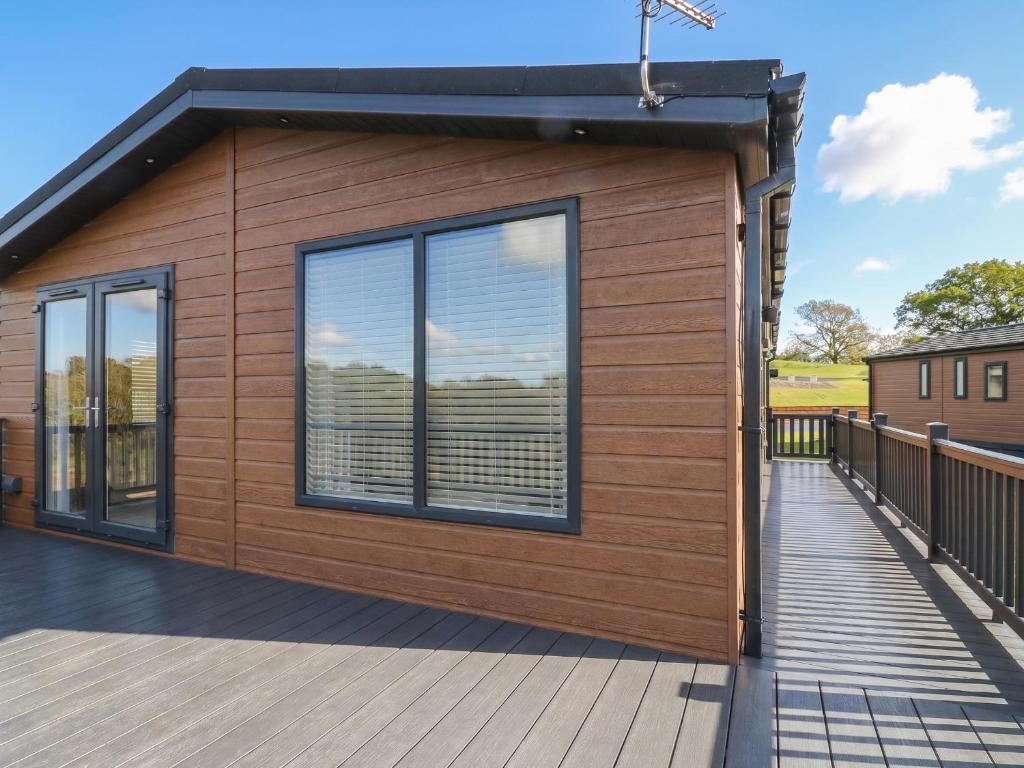 a small cabin with a deck at Number 35 in Blackburn