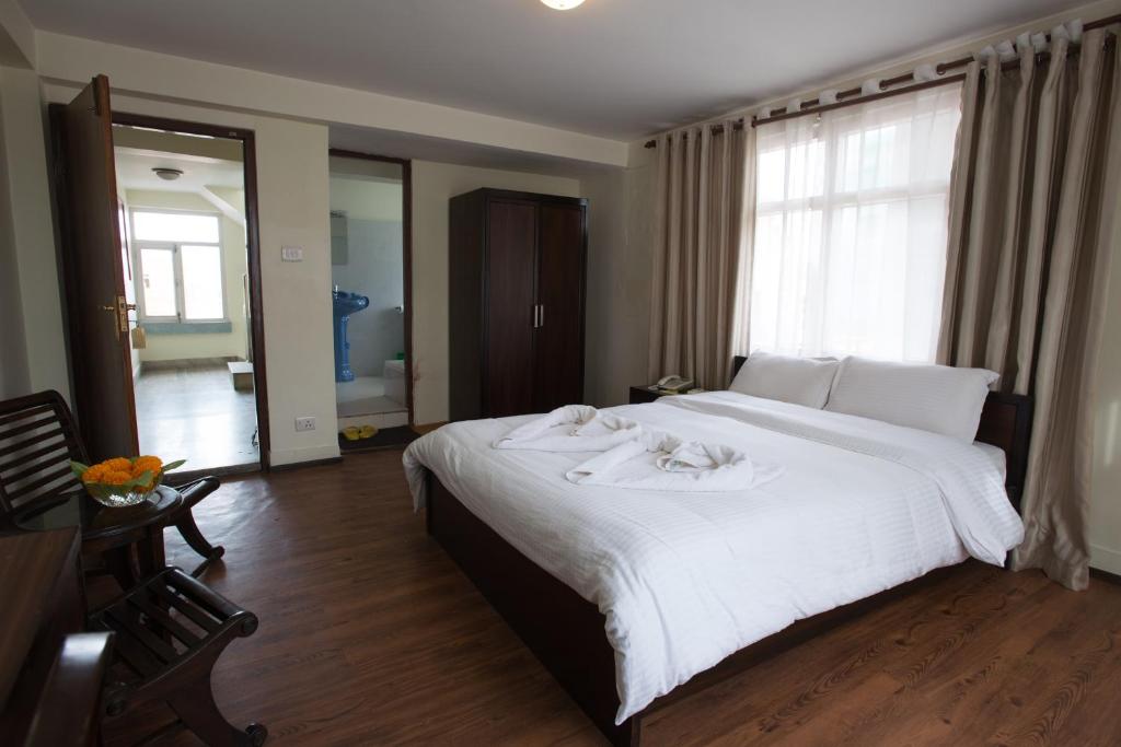 Postel nebo postele na pokoji v ubytování Hotel Yambu kathmandu