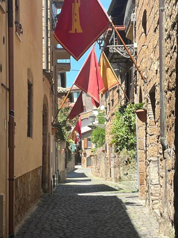 an alley with flags hanging over a street at Vicolo in Fiore House in Orvieto