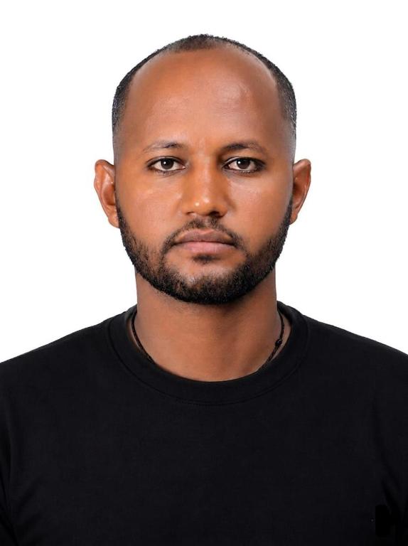 a man in a black shirt is looking at the camera at Blue bird in Addis Ababa