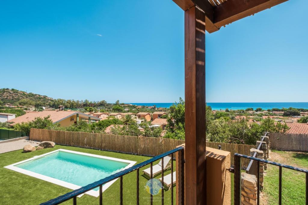 a view from the balcony of a house with a swimming pool at Villa Panorama Private Pool Costa Rei in Monte Nai