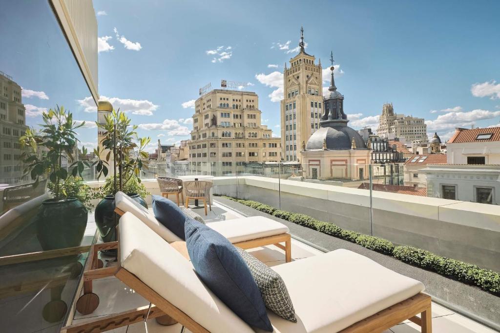 a balcony with a view of a city skyline at Nobu Hotel Madrid in Madrid