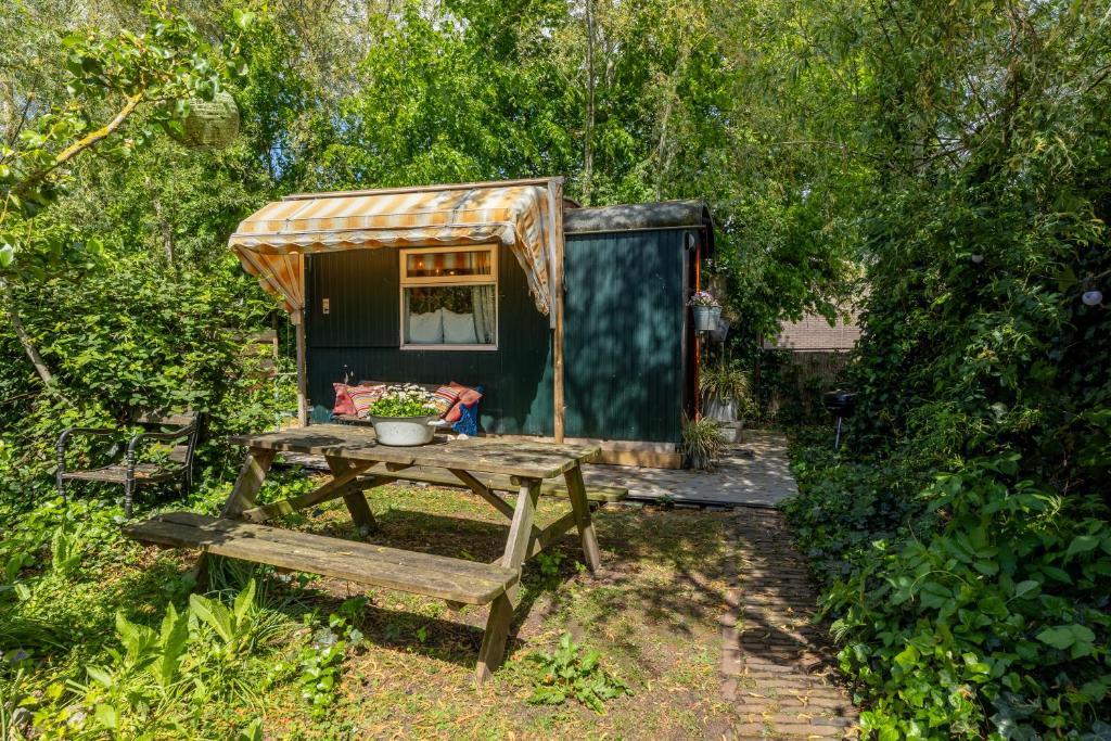 a picnic table in front of a tiny house at Tiny House in Kampen