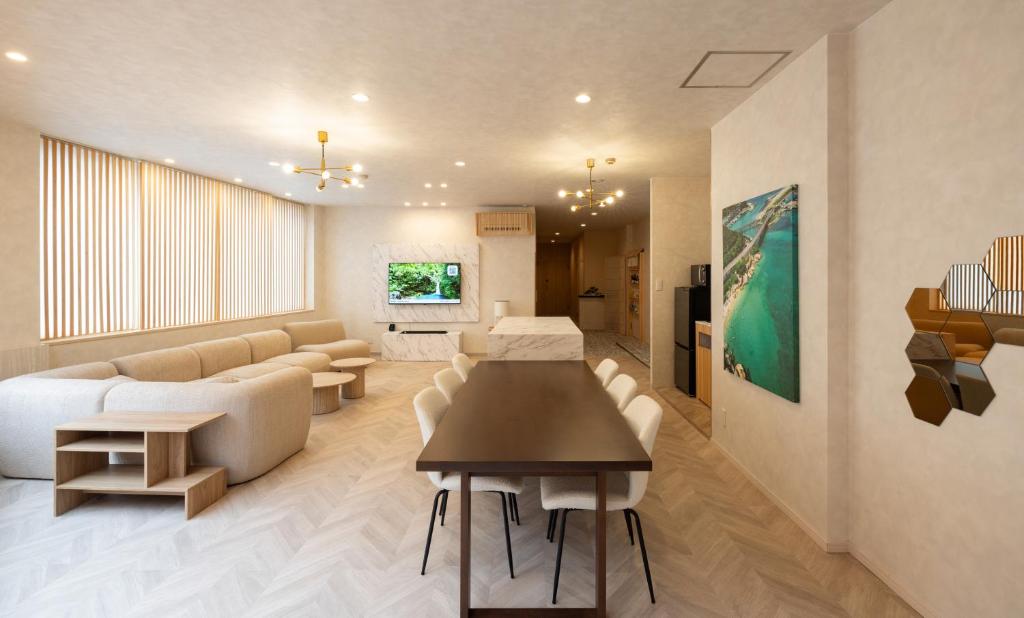 a living room with a couch and a table and chairs at Priyado Kochi in Kochi