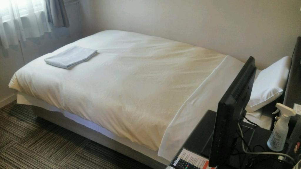 Postel nebo postele na pokoji v ubytování Hosplitality In Yawatajuku