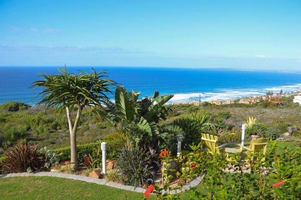 a garden with a view of the ocean at Classical View Guesthouse in Mossel Bay