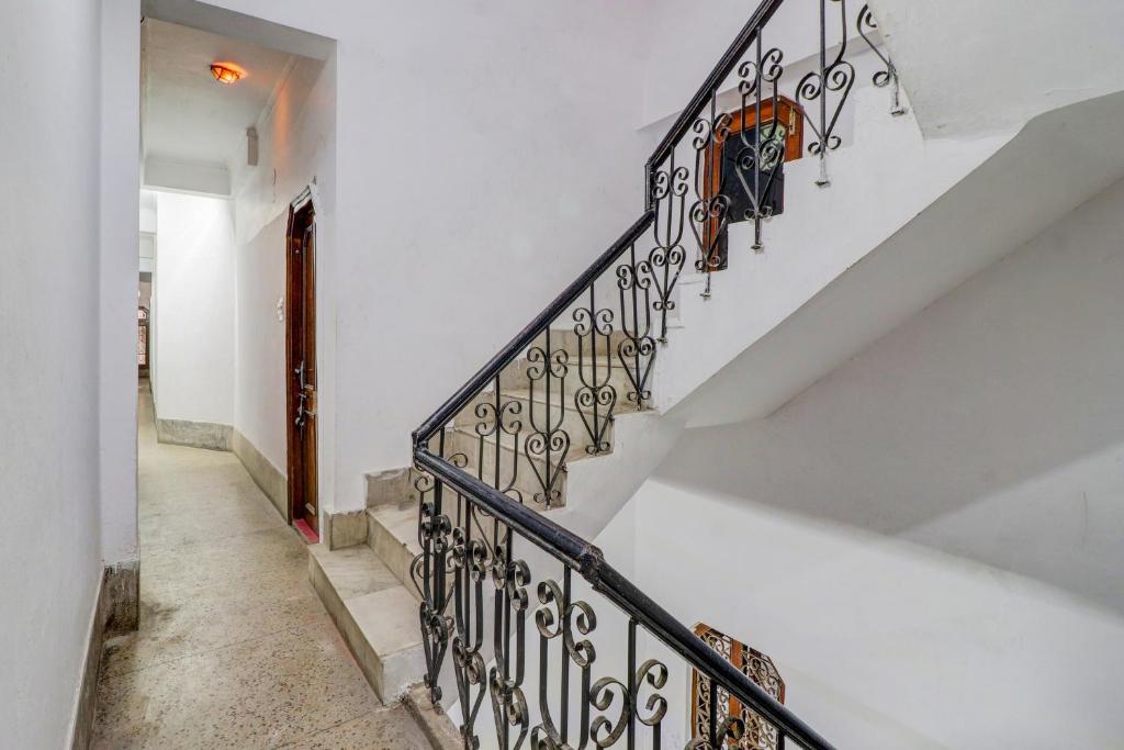 a staircase in a home with a wrought iron railing at Super Hotel O by OYO Kavish Residency in Haridwār