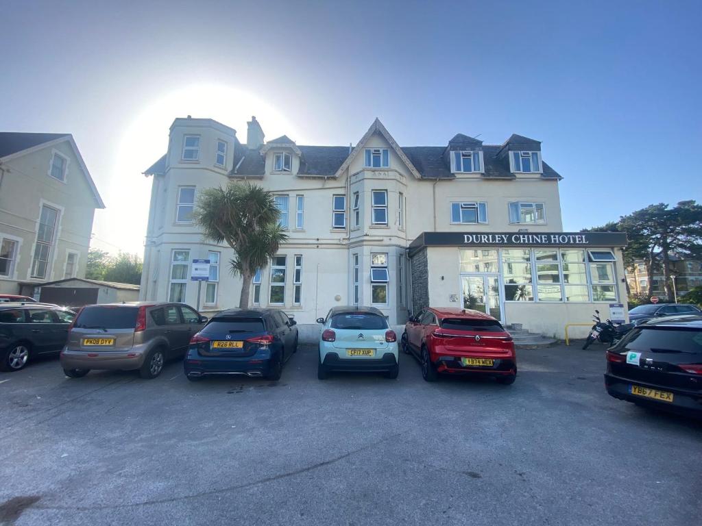 a group of cars parked in front of a building at The Durley Chine Hotel in Bournemouth