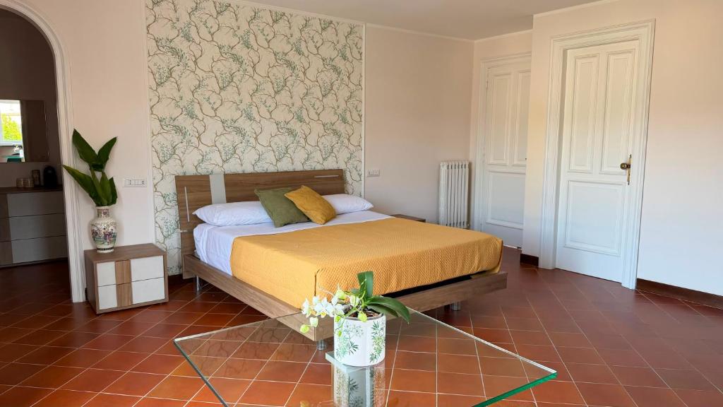 a bedroom with a bed and a glass table at Villa O'Serbante in Sant'Agnello