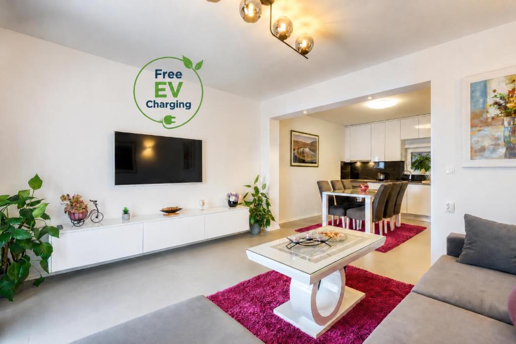 a living room with a tv and a table at Apartment Sea bass Neretva in Ploče