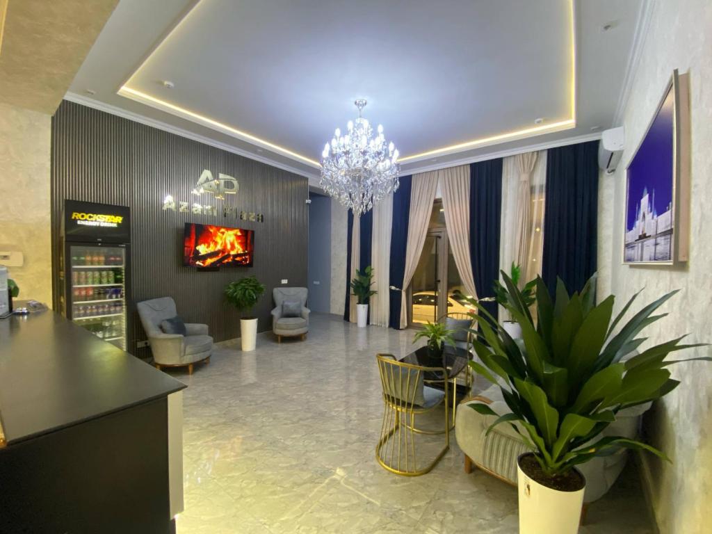 a lobby with chairs tables and a chandelier at Hotel Imam Azam in Samarkand