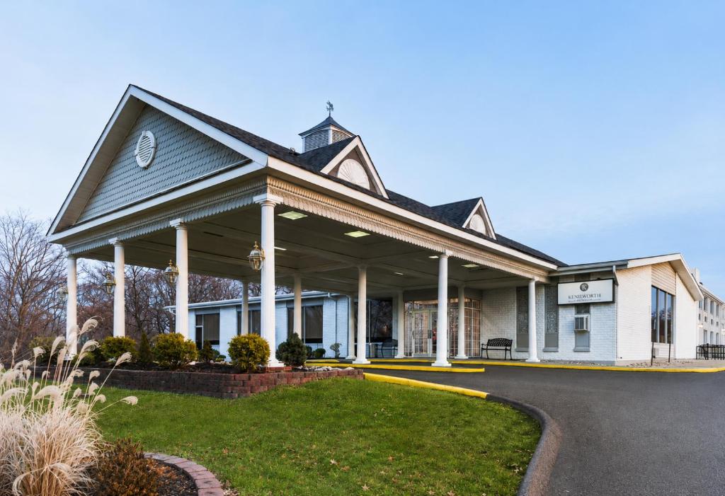 a white house with a gambrel roof at The Kenilworth Hotel - Airport West in Kenilworth