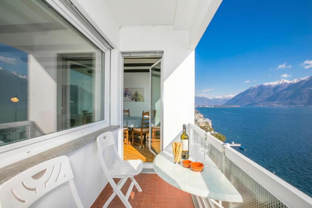 a balcony with a view of the water at On the Lake 2BR with Garage in Porto Ronco - Happy Rentals in Ronco sopra Ascona