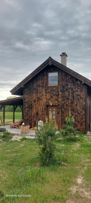 a log cabin with a window on the side of it at Chata pod kogutem in Barczewko