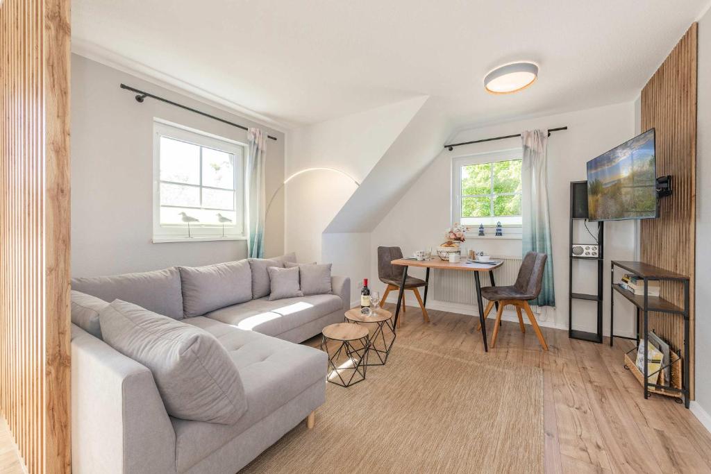 a living room with a couch and a table at Ferienwohnung Strandliebe in Koserow
