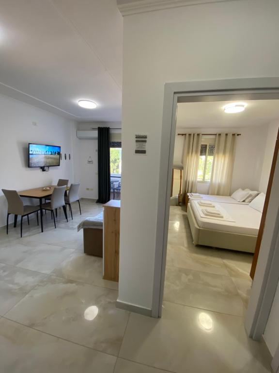 a bedroom and living room with a bed and a table at Beachfront Apartment Durres in Durrës
