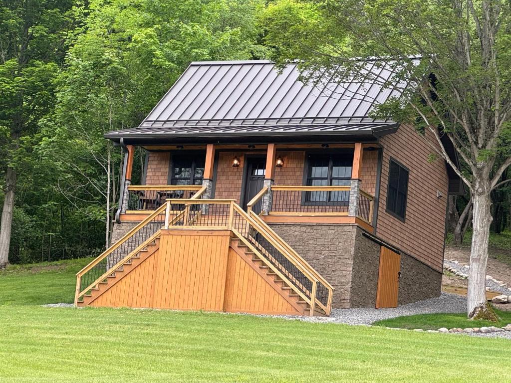 a house with a large deck on the front of it at The Old Orchard Cottage in LaFayette