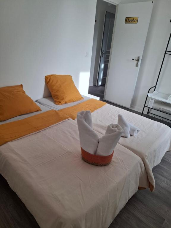 two beds with white shoes sitting on top of them at Flexygere 2 in Orléans