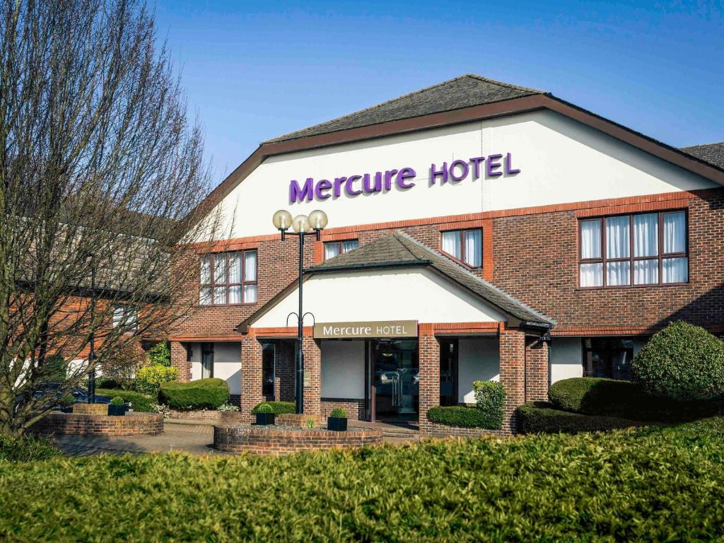 a hotel with a sign on the front of it at Mercure Dartford Brands Hatch Hotel & Spa in Dartford
