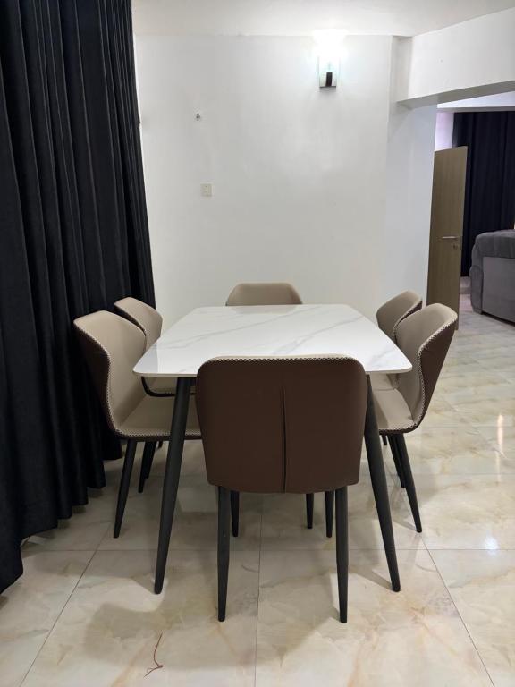 a white table and chairs in a room at Lochwood in Aso