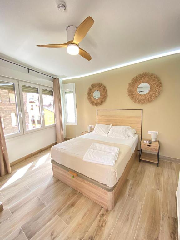 a bedroom with a bed and a ceiling fan at Grampy Boutique Hostal - Zaragoza Centro in Zaragoza