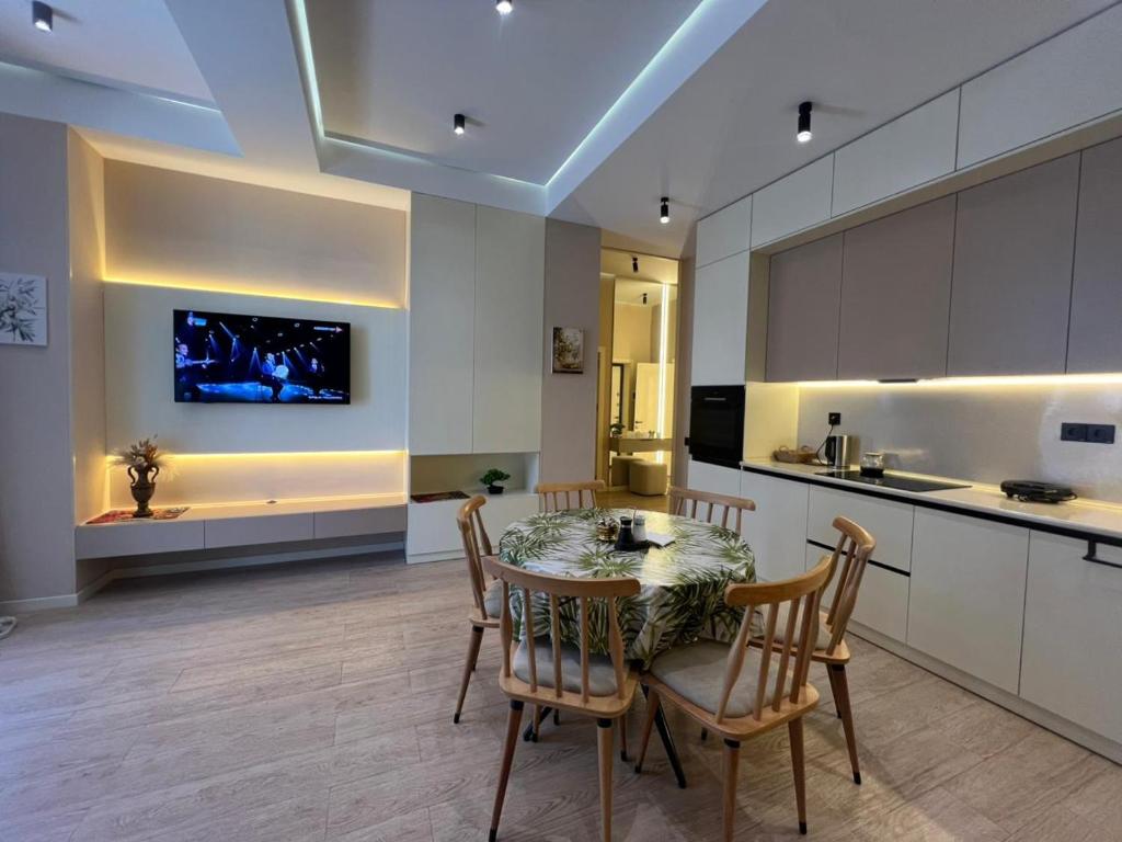 a kitchen with a table and chairs in a room at Sea Breeze Polo in Nardaran