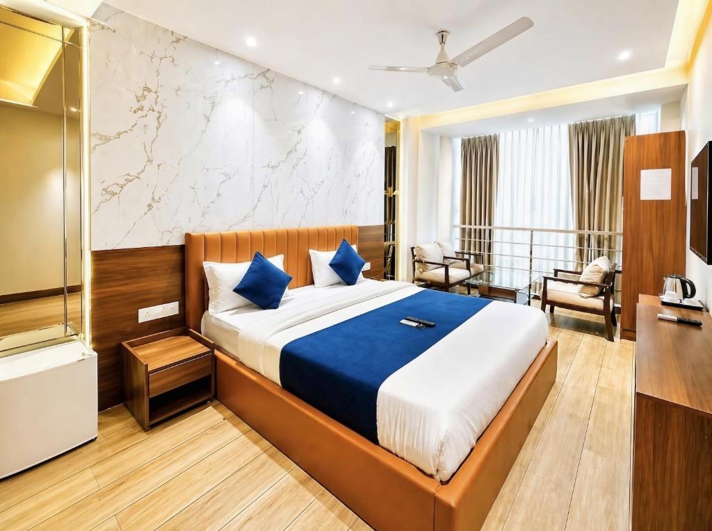 a bedroom with a large bed with blue pillows at Hotel Rs Inn - 5 Mints Walk From New Delhi Railway Station And Connaught Place in New Delhi
