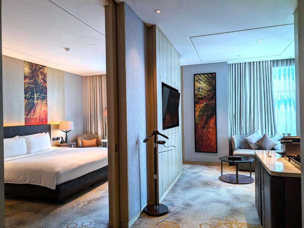A divided suite view shows the bed area on one side and a curtained sitting room on the other.