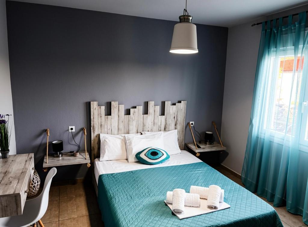 a bedroom with a bed with two towels on it at Aegli House in Theológos