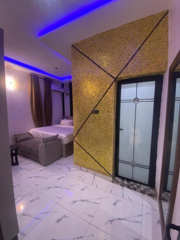 a bedroom with a bed and a large window at Spenza Hotel and Suites in Asaba