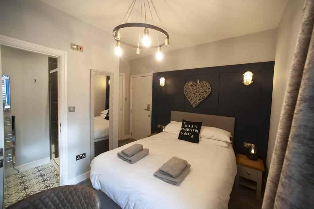 a bedroom with a bed with two towels on it at Modern Studio - Central Location in Southport