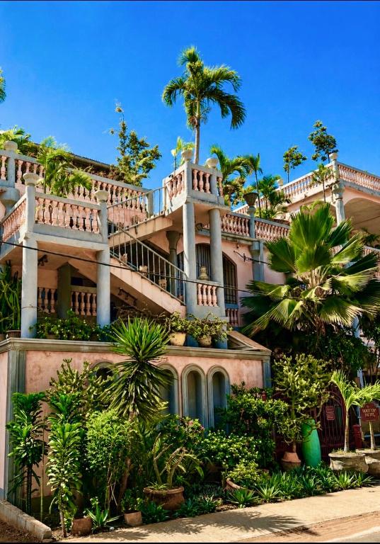 a large house with a staircase on top of it at RoofTop Boutique Hotel Adults Only in Serekunda