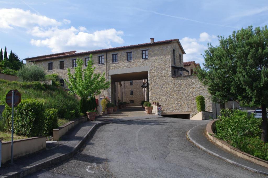 a building with a tunnel in the middle of a street at Roby's House in Gaiole in Chianti