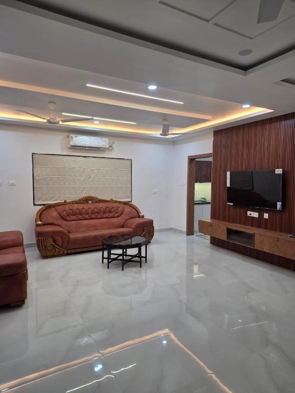 a living room with a couch and a flat screen tv at The Sanctuary by exot in Visakhapatnam