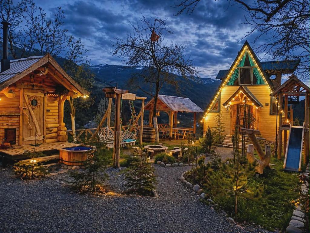 a log cabin with a playground in front of it at MOSES HOUSE-მოსეს სახლი in Baladzeyebi
