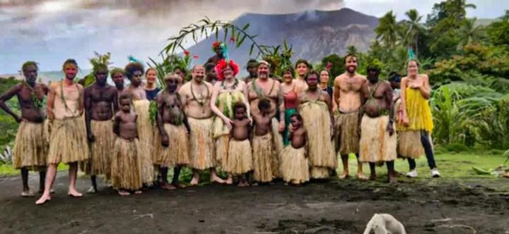 a group of men and women standing in a field at Yasur Adventure Tree house in Isangel