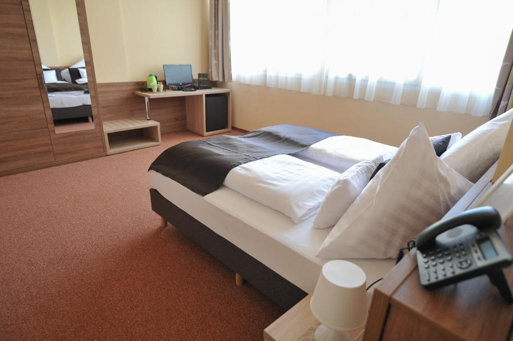 Łóżko lub łóżka w pokoju w obiekcie Centrooms Eger
