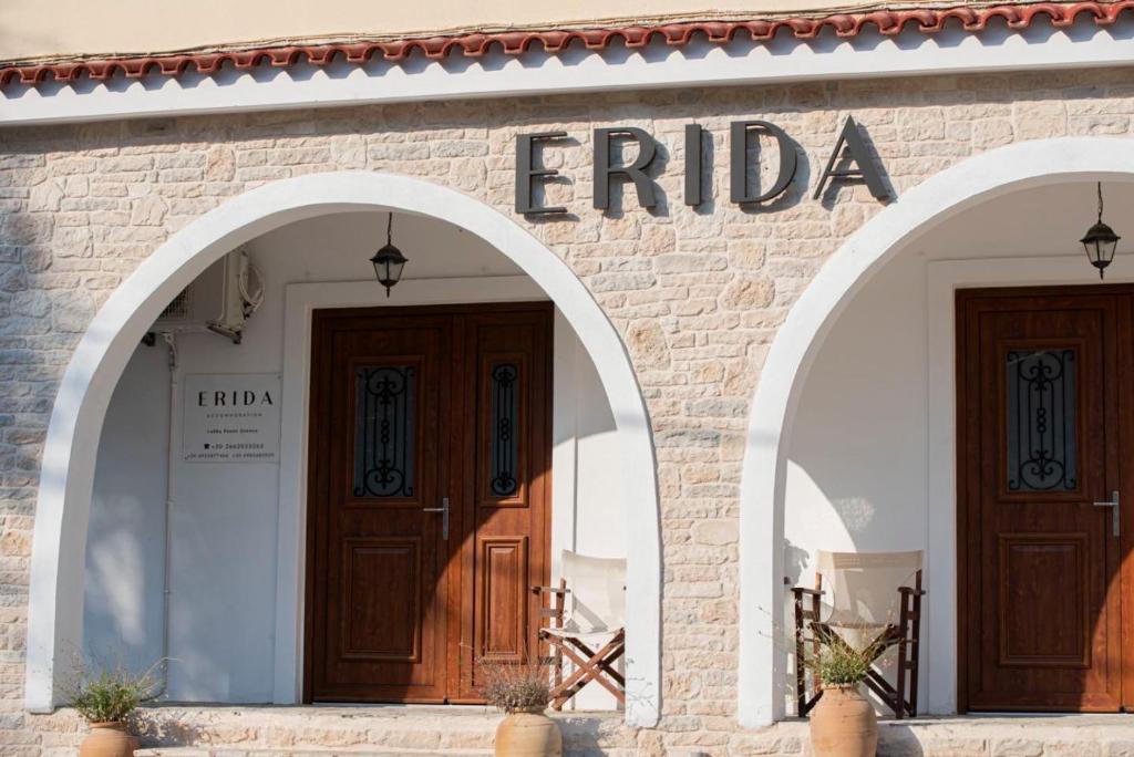 a facade of a building with two arch doors at ERIDA Accommodation in Lákka