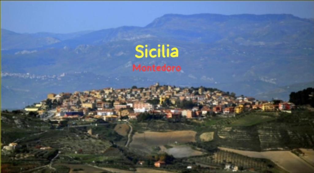 a city on top of a hill with a town at Sicilia Ambiente in Montedoro