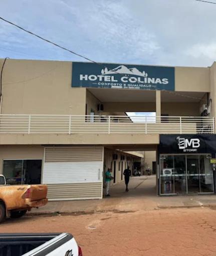 a building with a hotel columns sign on it at Hotel Colinas in Cajuapara