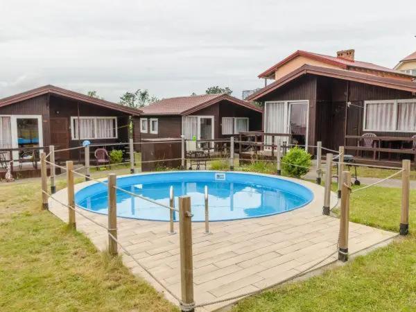 a swimming pool in the yard of a house at Osada Rybacka in Jastrzębia Góra