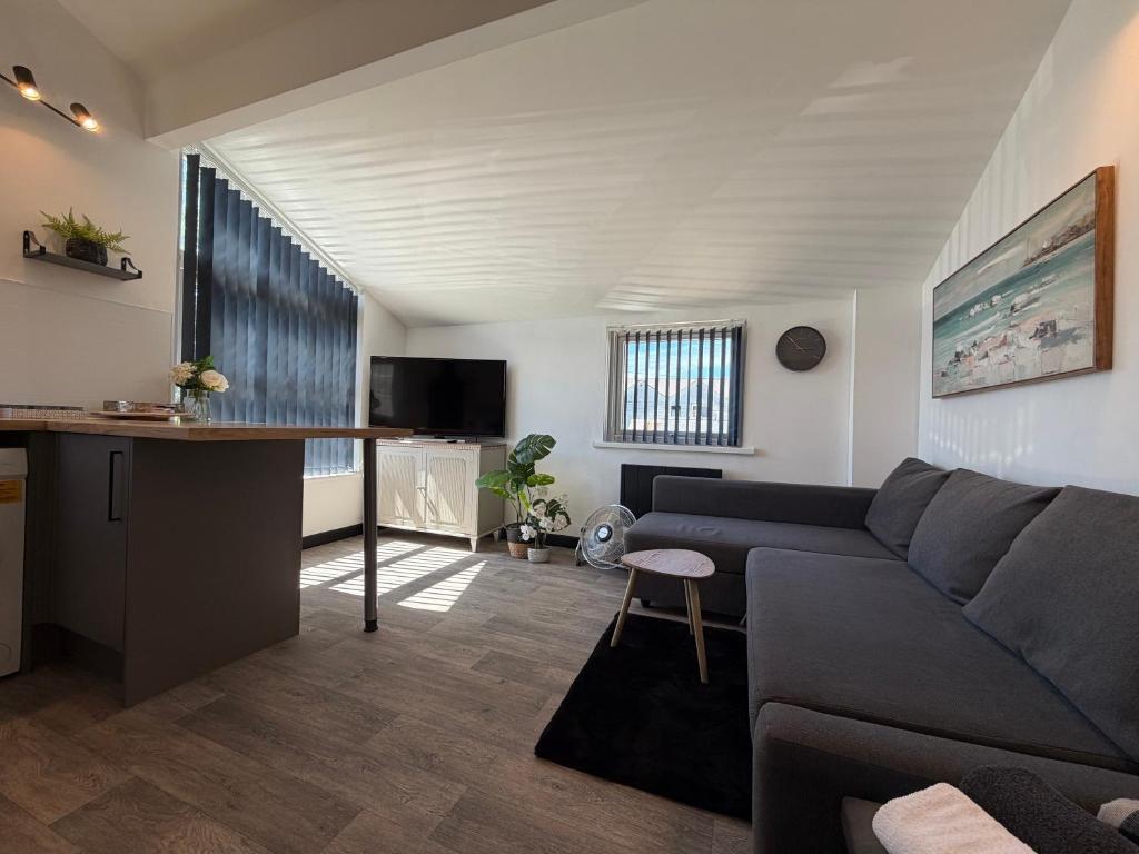 a living room with a couch and a table at Glowstay 2 in Lampeter